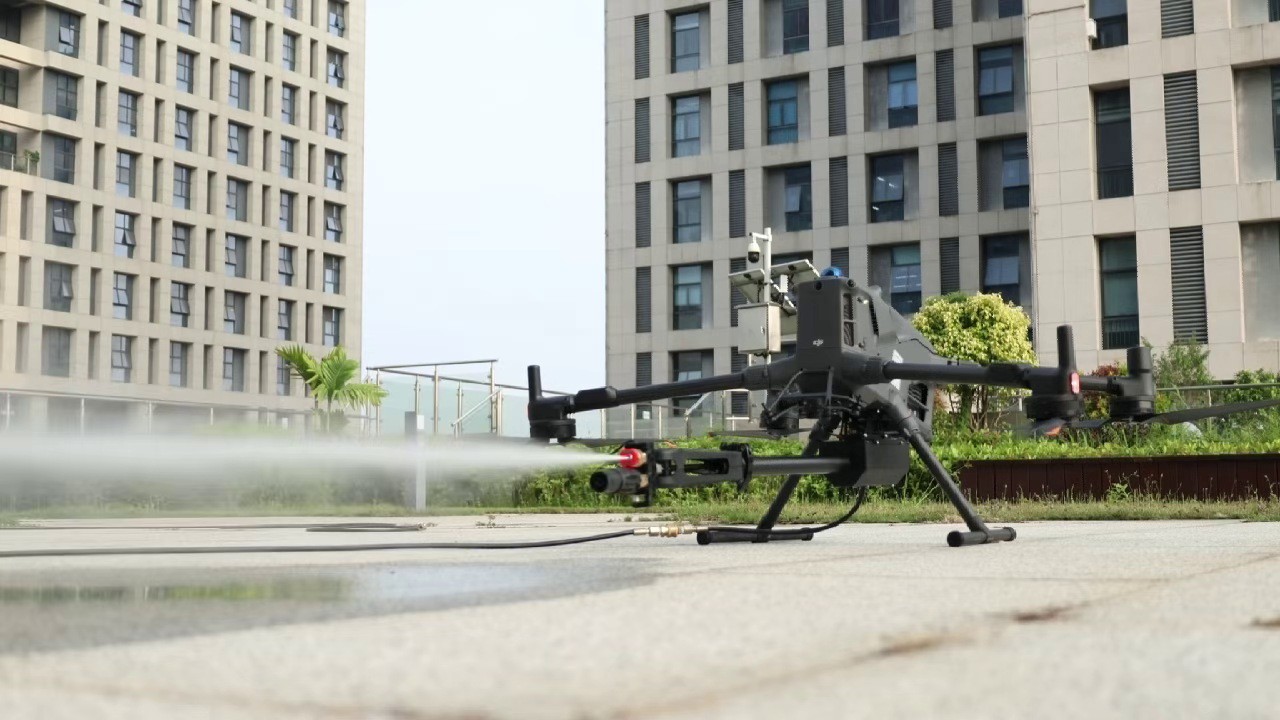 Dron DJI Matrice 400 s mycím ramenem, z trysky stříká voda